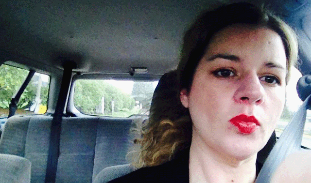 Christa driving a car.